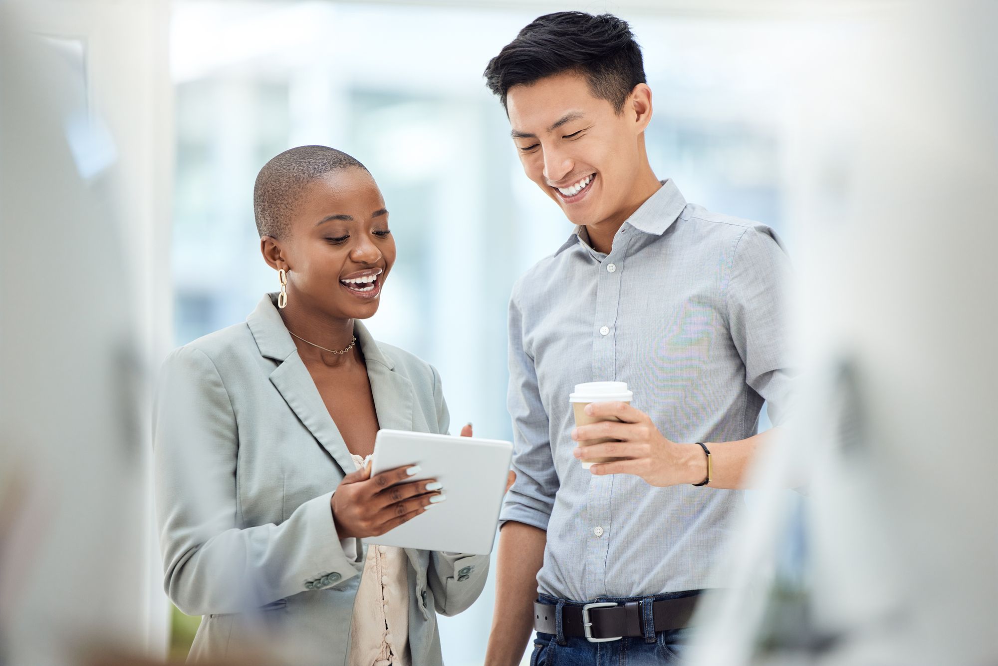 Male and female collaborating while checking data at work.