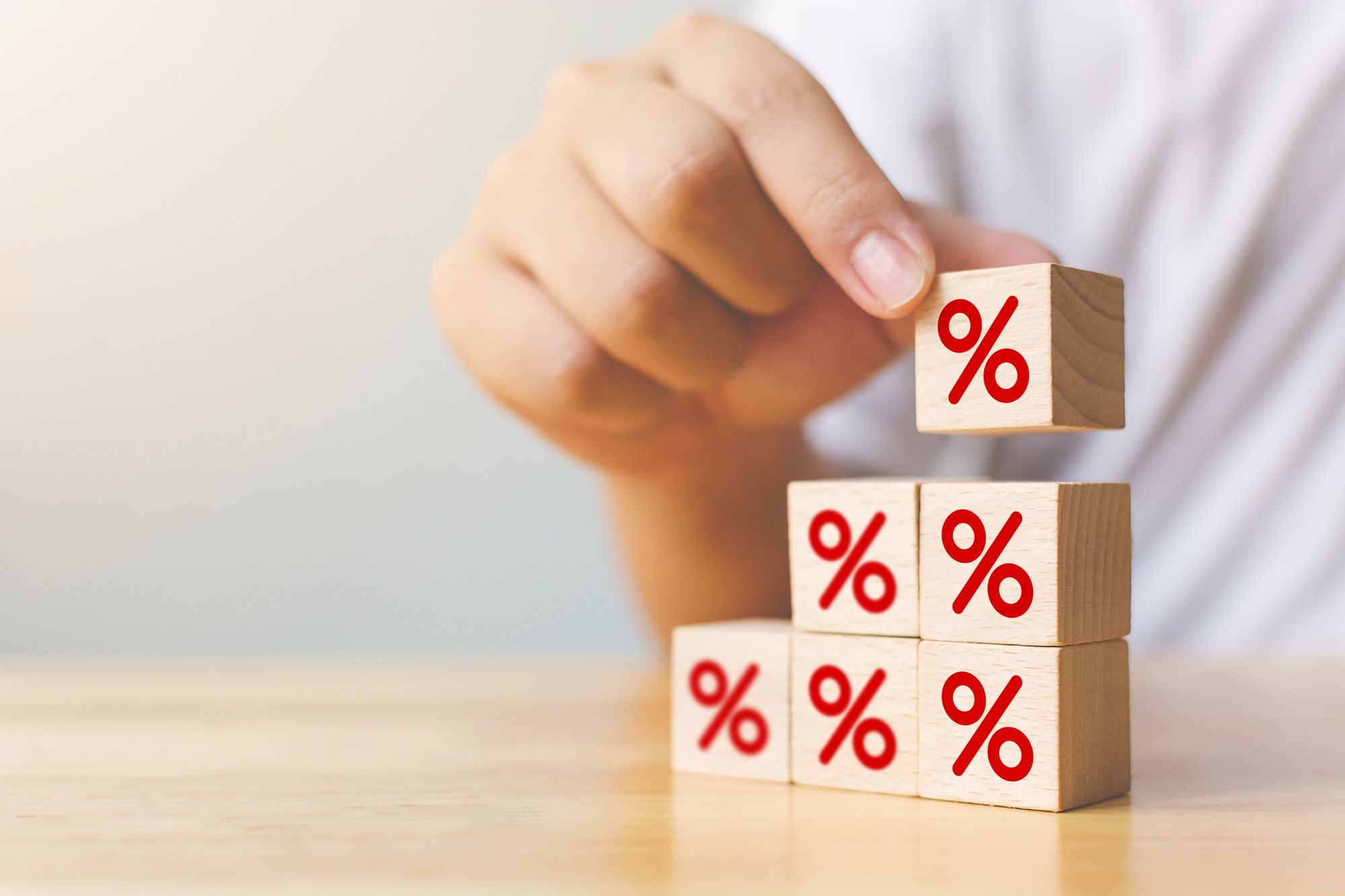 Stacking wooden blocks with division signs printed on them.