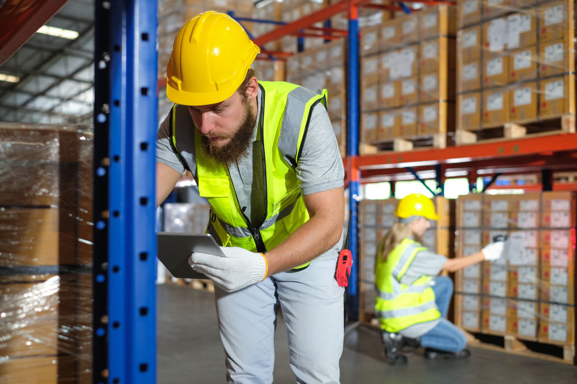 Workers inside the warehouse checking inventory through barcodes.